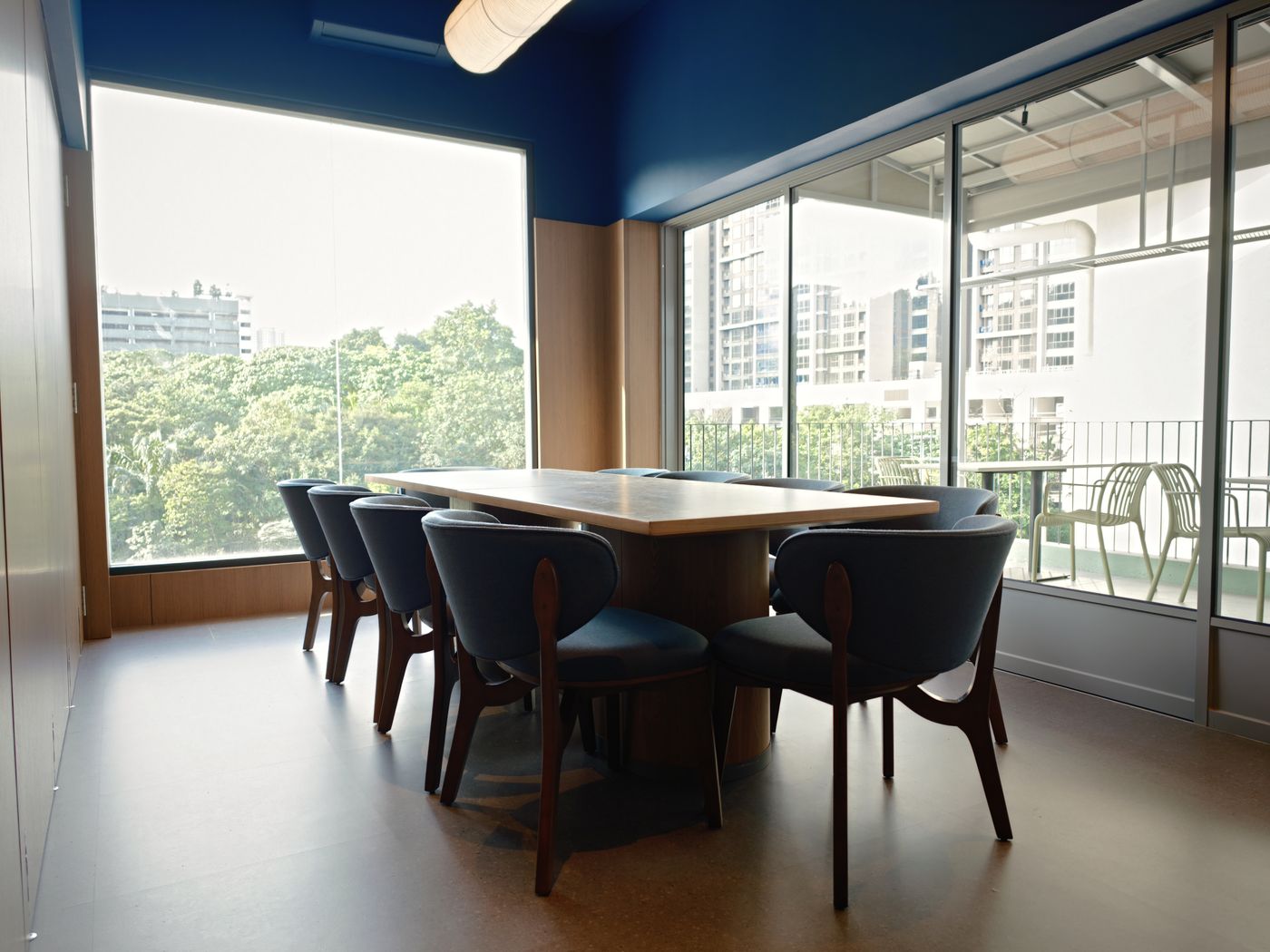 Private dining room at STEKA with a long table for eight and full-height windows over Mont Kiara